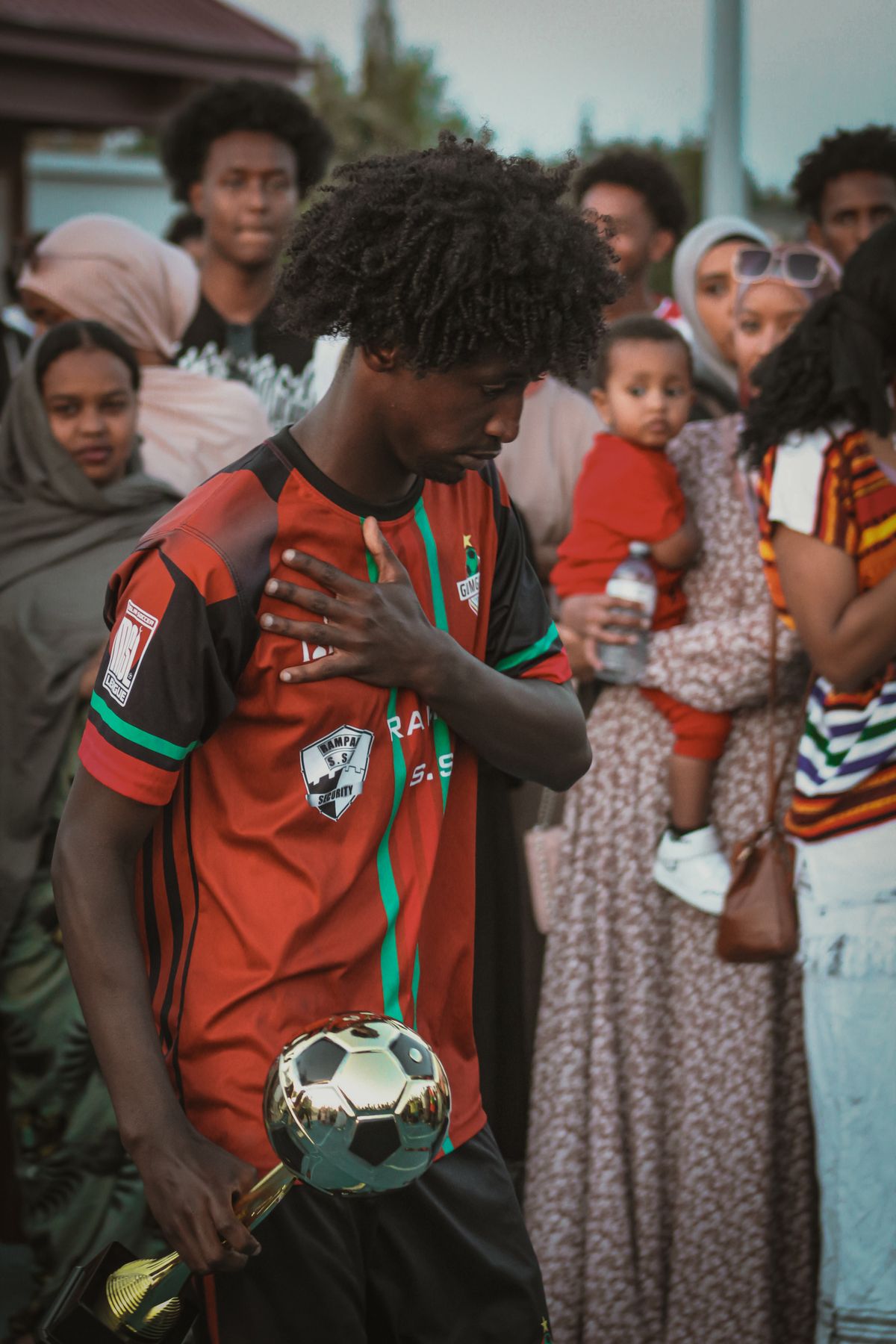 Player holding a golden ball trophy